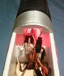 End pin receiver on shelf forward of battery tray.