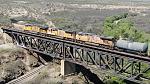 Only train to pass while I was out yesterday, moving quick over the high trestle on the old line.