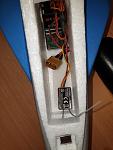 Receiver flat, the remote goes on its side to wedge the battery