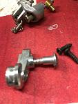 How is this connected to the idler wheel?  No threads so I guess a bolt and nut?