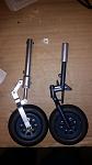 Strut with my extended linkage next to stock strut