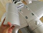 Magnetic cover conceals the screws for the center section. Wings also unscrew outboard of the engine nacelles.