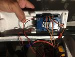 The circuit board is secured to the battery hatch. Mount it as far back as possible so it doesn't interfere with the battery.